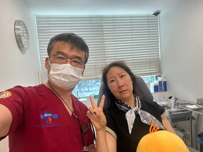 Dr. Kang taking a photo with a patient in a Pascal Clinic exam room, photo 4