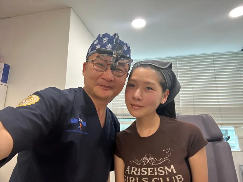 Dr. Kang taking a photo with a patient in a Pascal Clinic exam room, photo 18