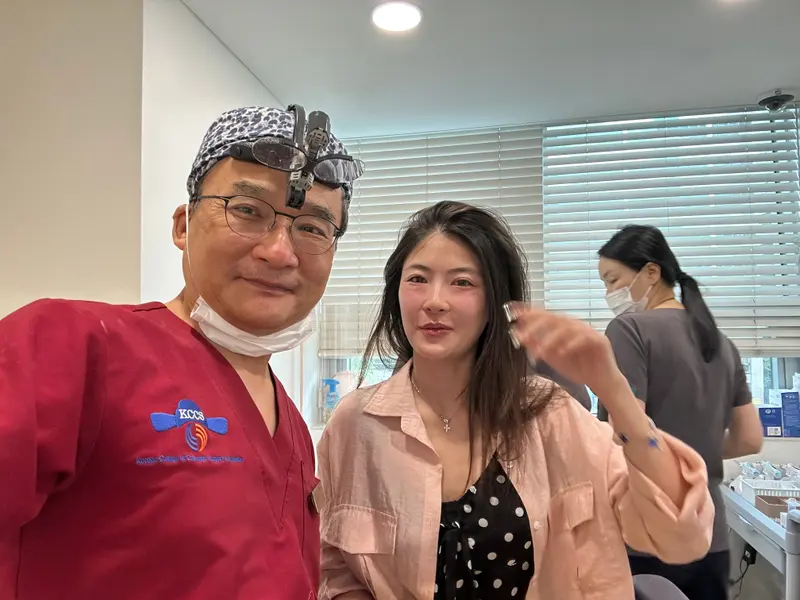 Dr. Kang taking a photo with a patient in a Pascal Clinic exam room, photo 21