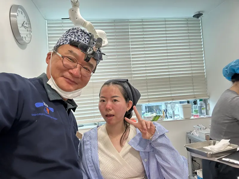 Dr. Kang taking a photo with a patient in a Pascal Clinic exam room, photo 24